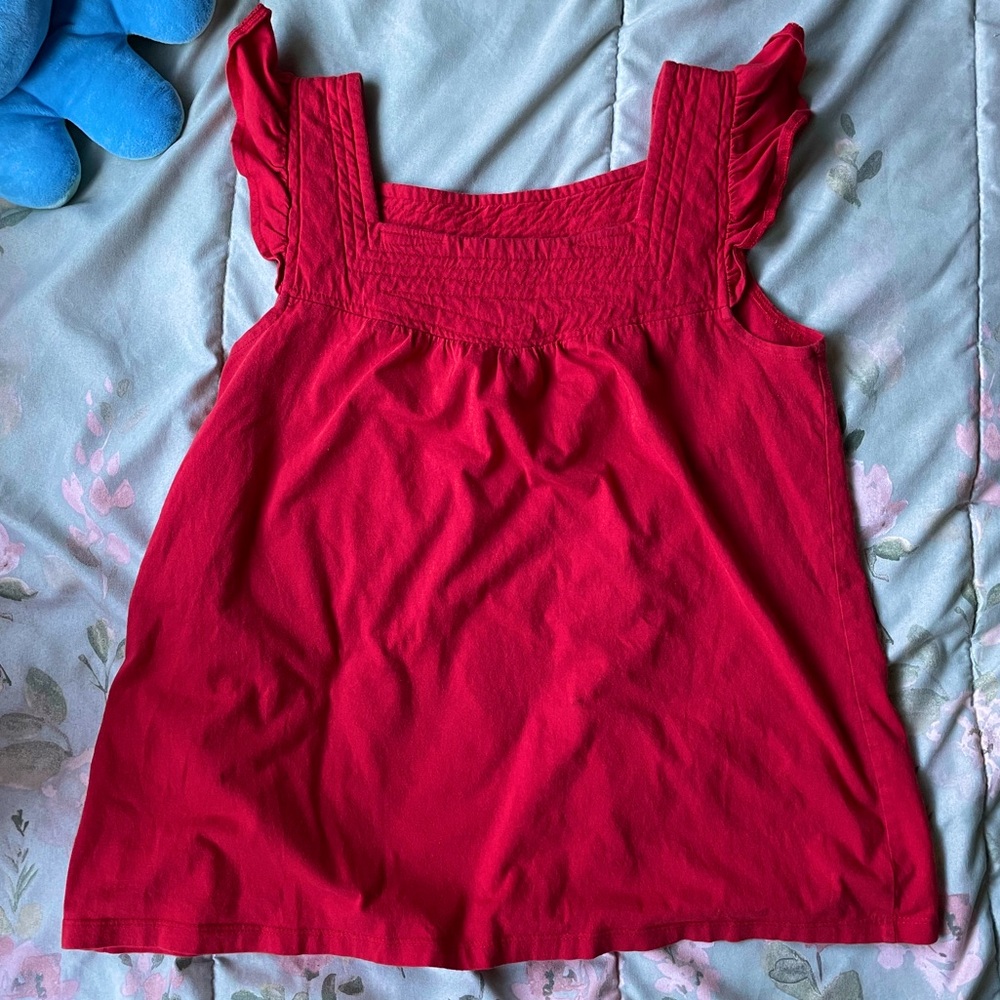 Flowy red babydoll blouse with ruffles at the sleeves
